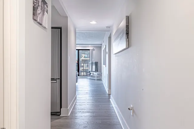 a view of hallway with wooden floor