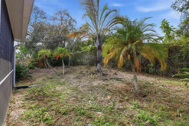 a backyard of a house with plants and outdoor seating