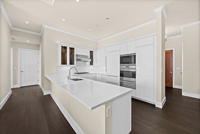a large white kitchen with a sink