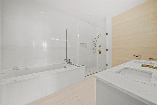 a spacious bathroom with a tub sink and mirror