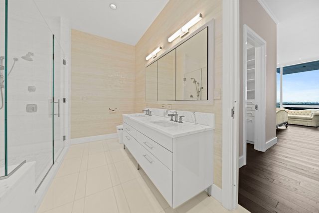 a spacious bathroom with a sink and a mirror