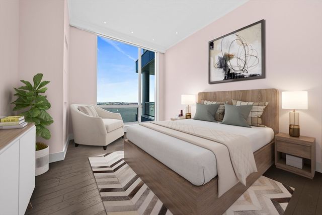 a bedroom with a bed and a potted plant