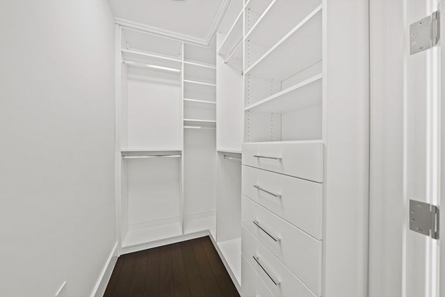 a view of walk in closet with empty racks