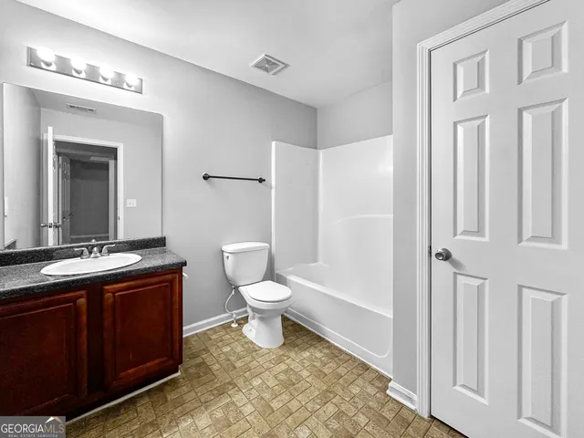 a bathroom with a toilet a sink and a mirror