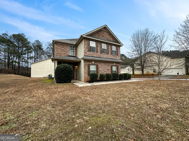 a front view of a house with a yard