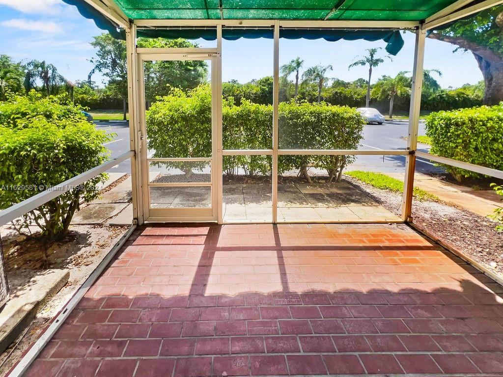 369 Waterside Drive, Unit 369 Hypoluxo, FL 33462 - Photo 13 of 23 a view of a balcony with floor to ceiling windows with wooden floor