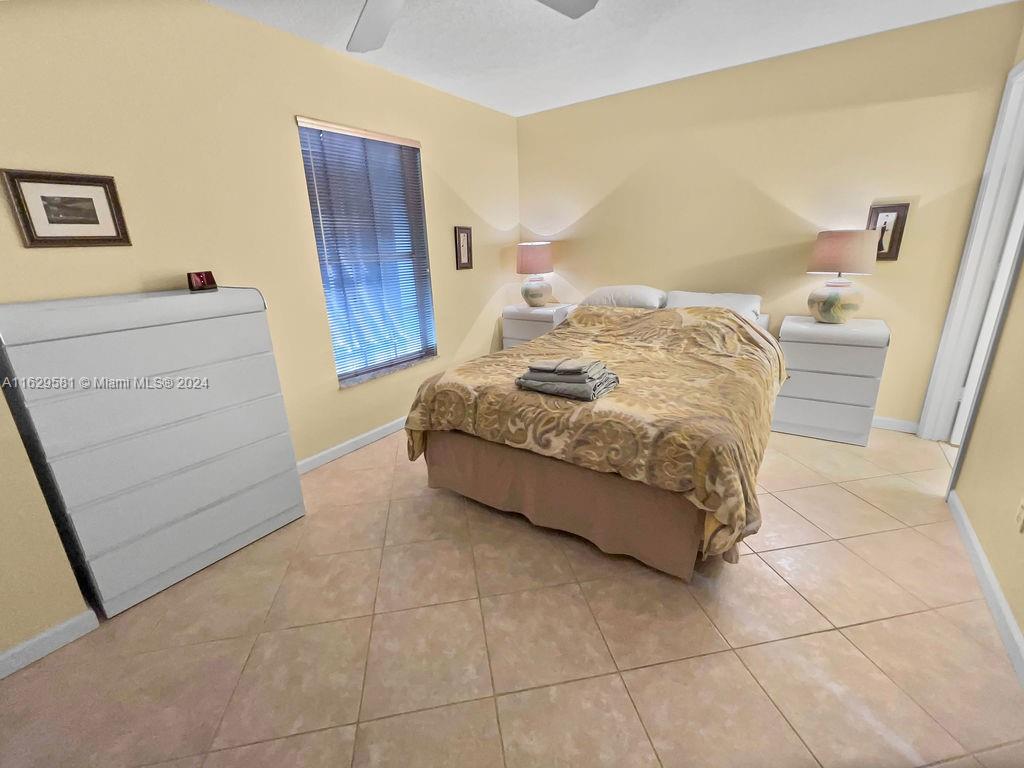 369 Waterside Drive, Unit 369 Hypoluxo, FL 33462 - Photo 15 of 23 a bedroom with a bed and a dresser