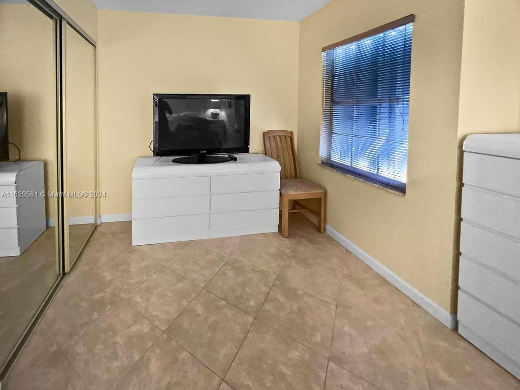 369 Waterside Drive, Unit 369 Hypoluxo, FL 33462 - Photo 16 of 23 a living room with furniture and a flat screen tv