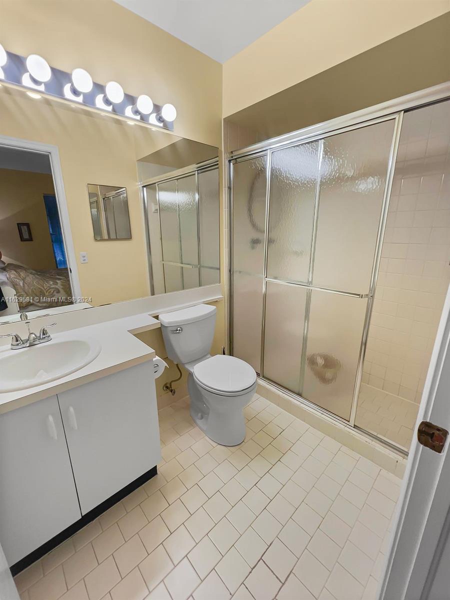 369 Waterside Drive, Unit 369 Hypoluxo, FL 33462 - Photo 19 of 23 a bathroom with a sink mirror vanity and toilet