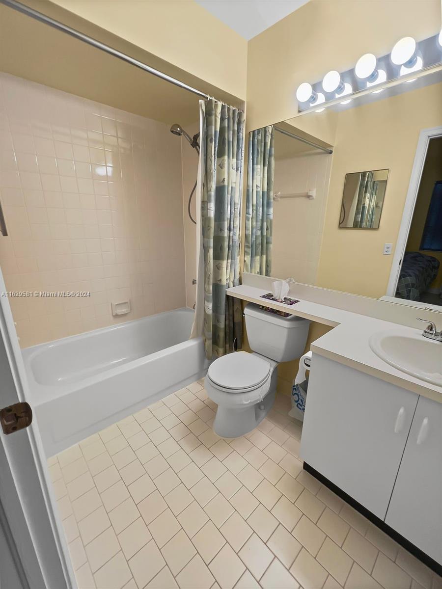 369 Waterside Drive, Unit 369 Hypoluxo, FL 33462 - Photo 20 of 23 a bathroom with a sink mirror vanity and toilet