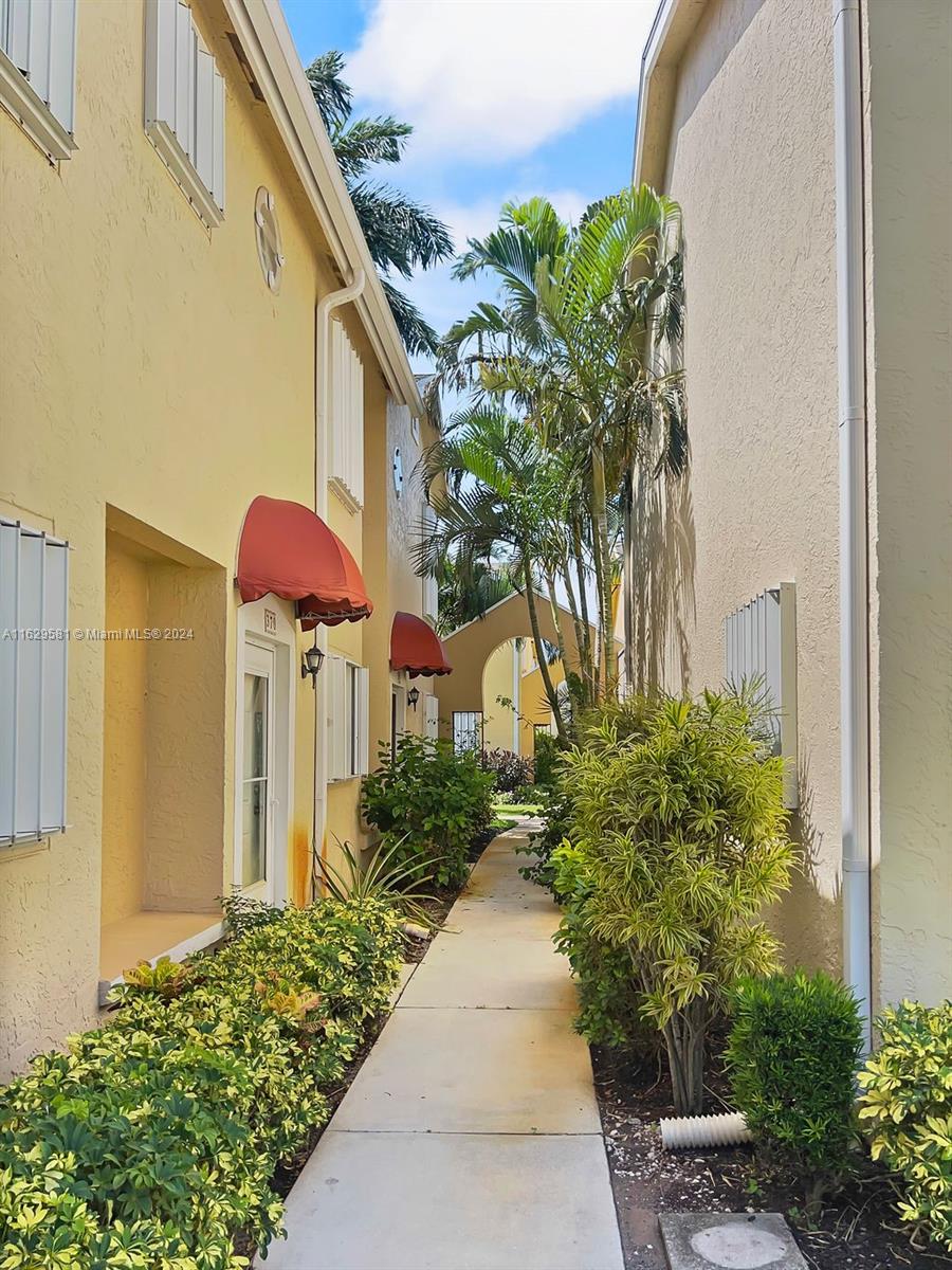 369 Waterside Drive, Unit 369 Hypoluxo, FL 33462 - Photo 2 of 23 a backyard of a house with lots of green space
