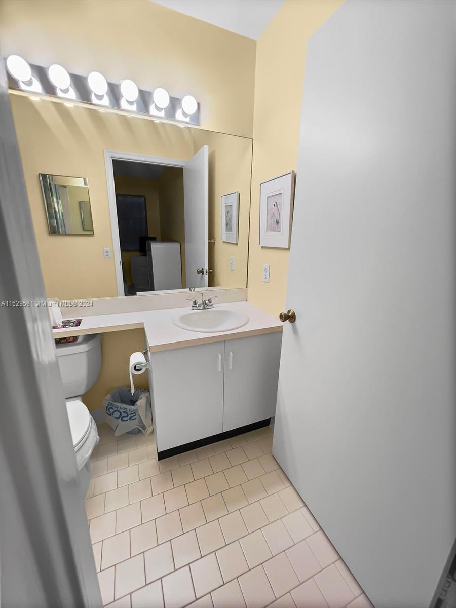 369 Waterside Drive, Unit 369 Hypoluxo, FL 33462 - Photo 21 of 23 a bathroom with a sink mirror and vanity
