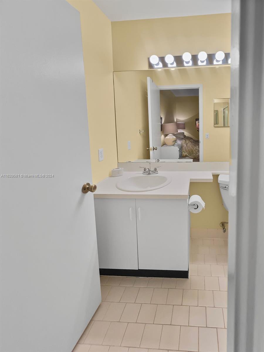 369 Waterside Drive, Unit 369 Hypoluxo, FL 33462 - Photo 22 of 23 a bathroom with a sink and a mirror