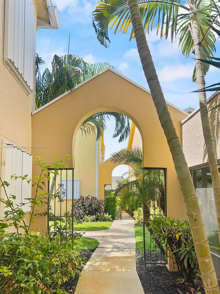 369 Waterside Drive, Unit 369 Hypoluxo, FL 33462 - Photo 3 of 23 a front view of a house with a yard