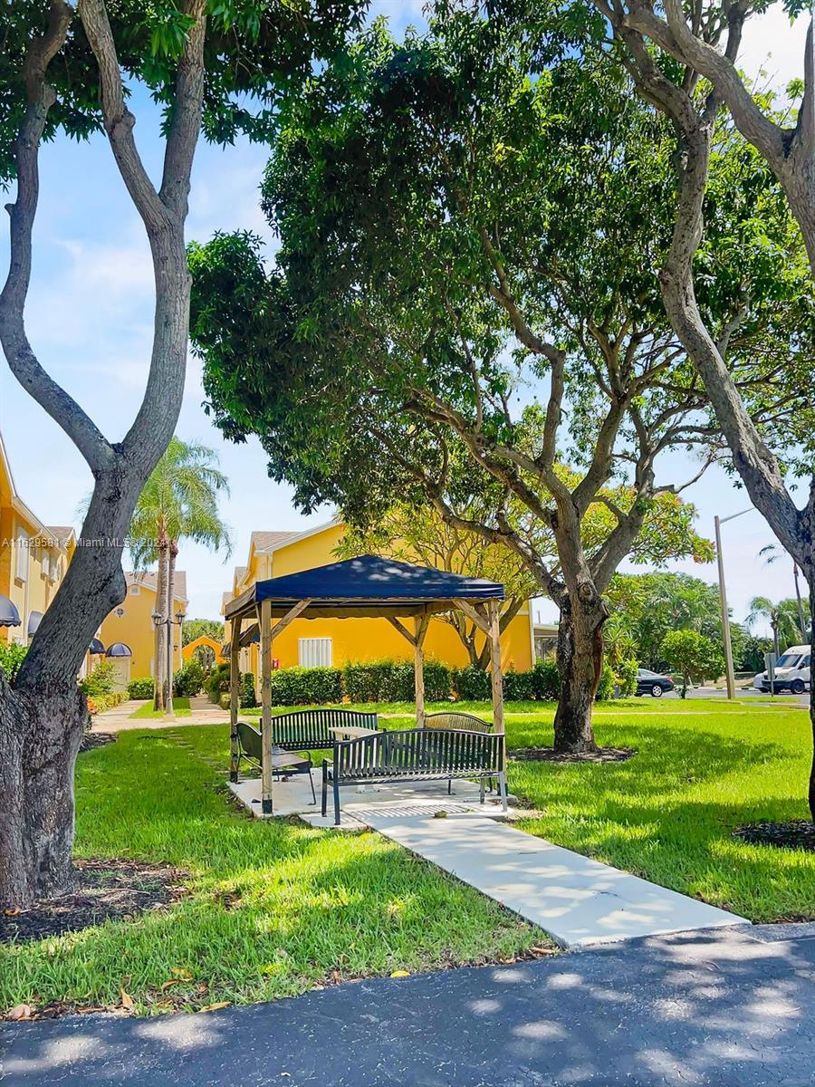 369 Waterside Drive, Unit 369 Hypoluxo, FL 33462 - Photo 4 of 23 a view of swimming pool with garden and trees