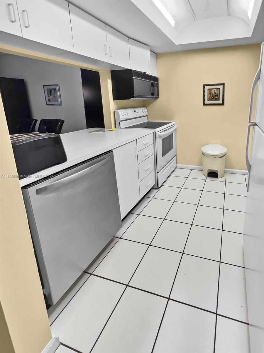 369 Waterside Drive, Unit 369 Hypoluxo, FL 33462 - Photo 5 of 23 a view of a kitchen with a sink and a stove top oven