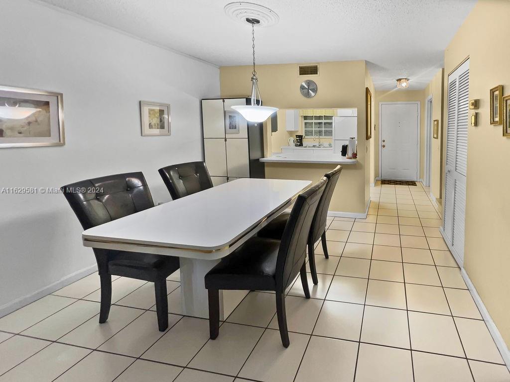 369 Waterside Drive, Unit 369 Hypoluxo, FL 33462 - Photo 7 of 23 a view of a dining room with furniture