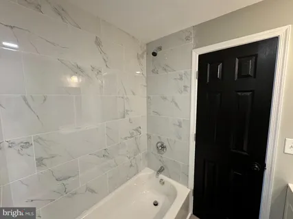 a bathroom with a bathtub and shower