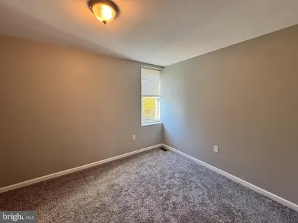 an empty room with window and closet