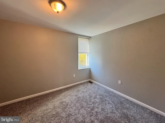 an empty room with window and closet