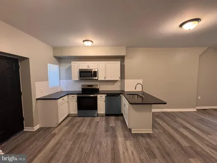 a kitchen with stainless steel appliances a sink and a stove
