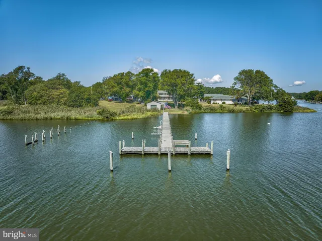 a view of a lake with a table and chairs