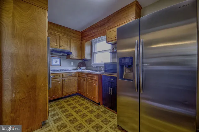 a kitchen with a refrigerator and cabinets