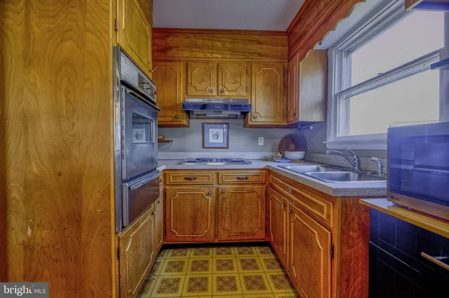 a kitchen with stainless steel appliances granite countertop a sink and a cabinets