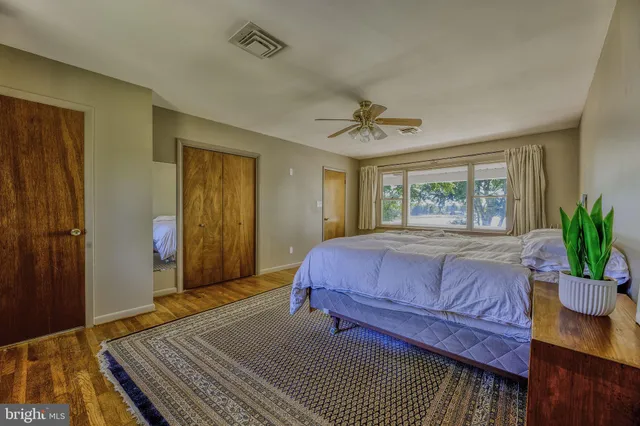 a bedroom with a large bed and a dresser