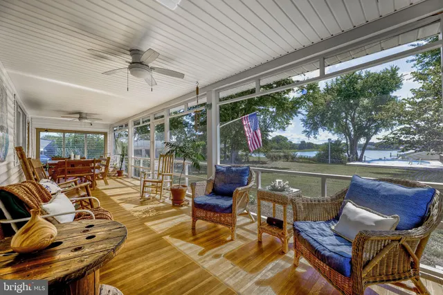 a living room with patio furniture and a floor to ceiling window