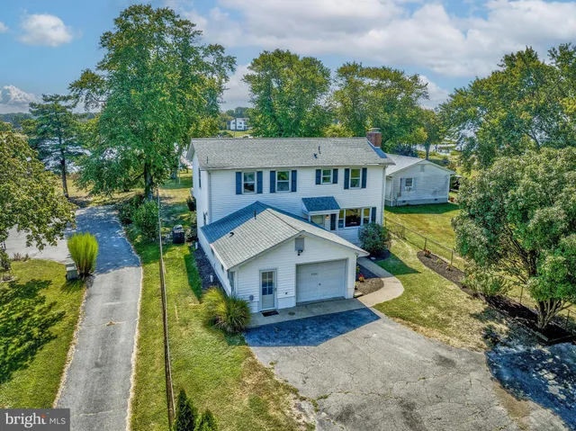 an aerial view of a house with a big yard