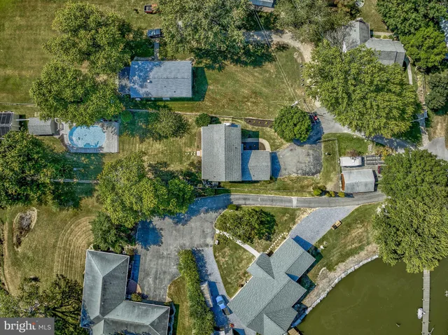an aerial view of a house with a yard basket ball court and outdoor seating