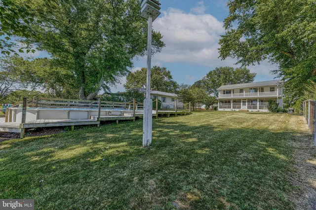 a view of house with a backyard