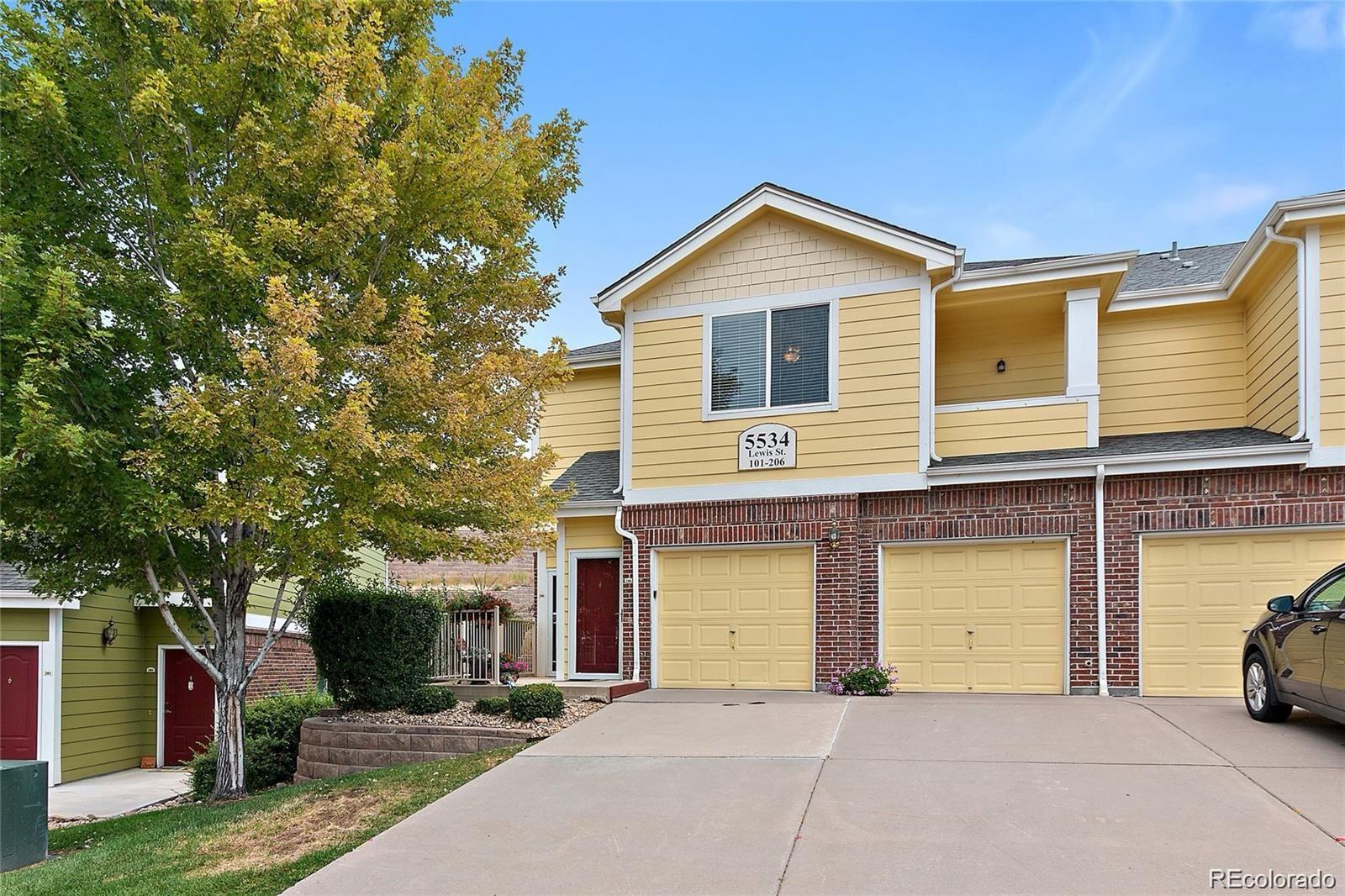 5534 Lewis Street, Unit 206 Arvada, CO 80002 - Photo 1 of 27 a view of a house with a yard and garage