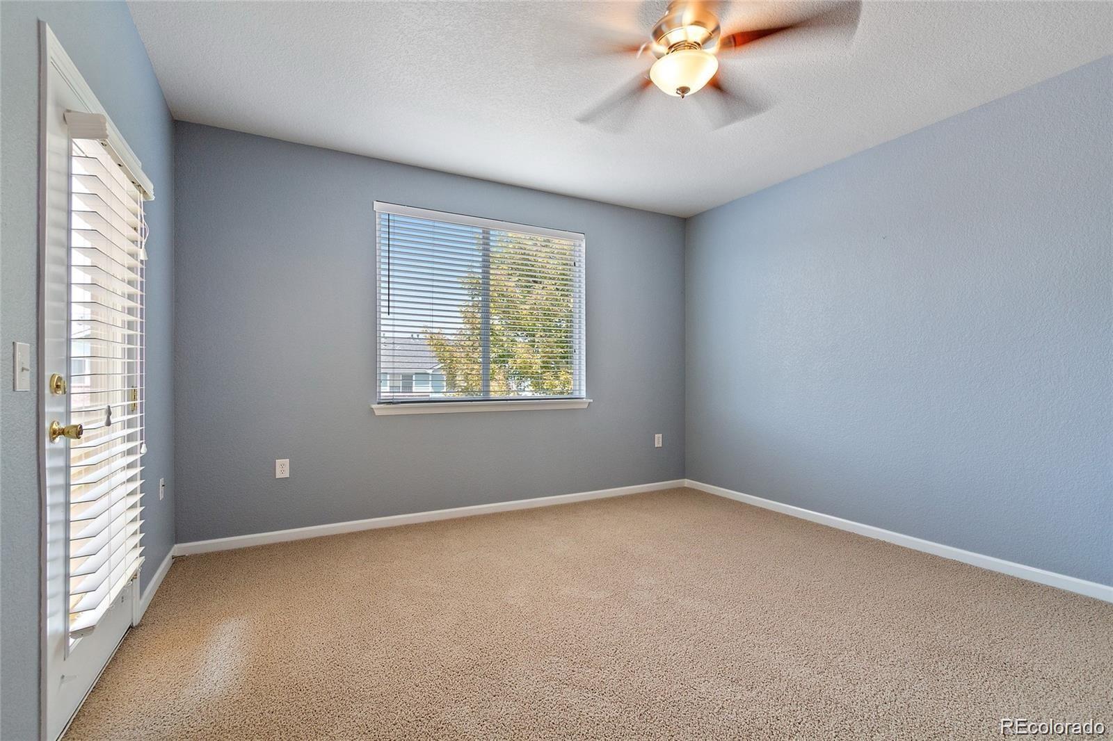 5534 Lewis Street, Unit 206 Arvada, CO 80002 - Photo 15 of 27 an empty room with a window and a ceiling fan
