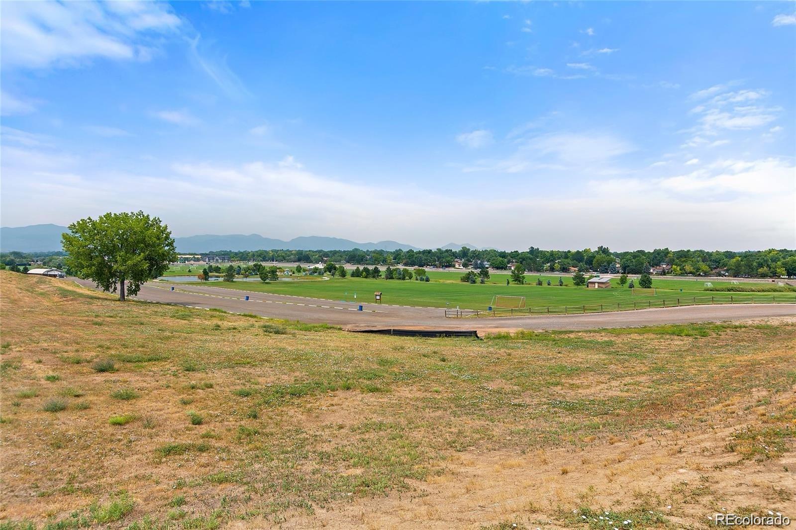 5534 Lewis Street, Unit 206 Arvada, CO 80002 - Photo 27 of 27 a view of a lake with houses in the back