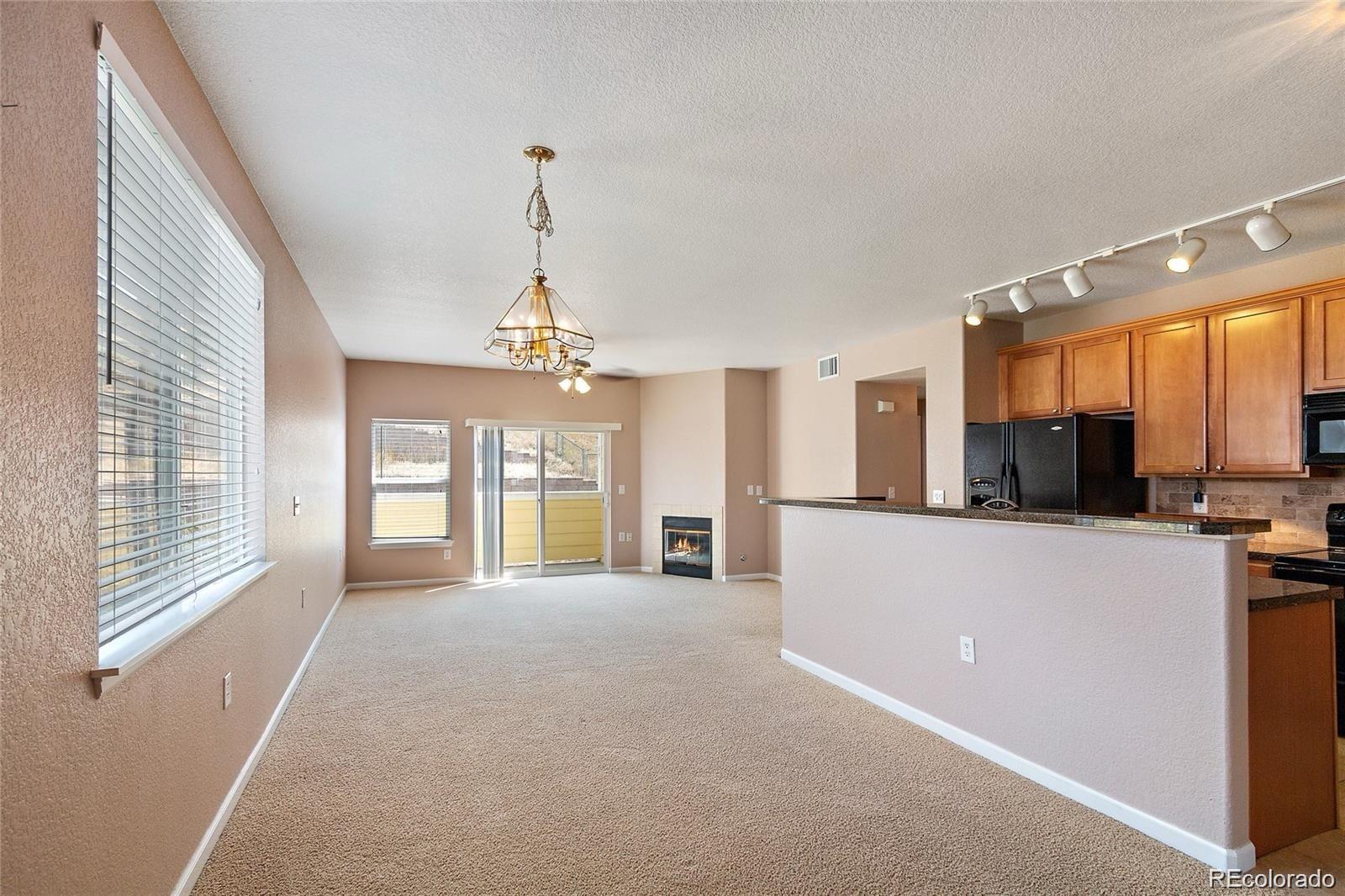 5534 Lewis Street, Unit 206 Arvada, CO 80002 - Photo 3 of 27 a view of a kitchen with a sink and a window