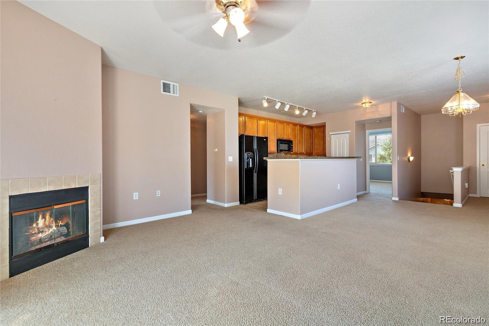 5534 Lewis Street, Unit 206 Arvada, CO 80002 - Photo 5 of 27 a view of an empty room with a fireplace