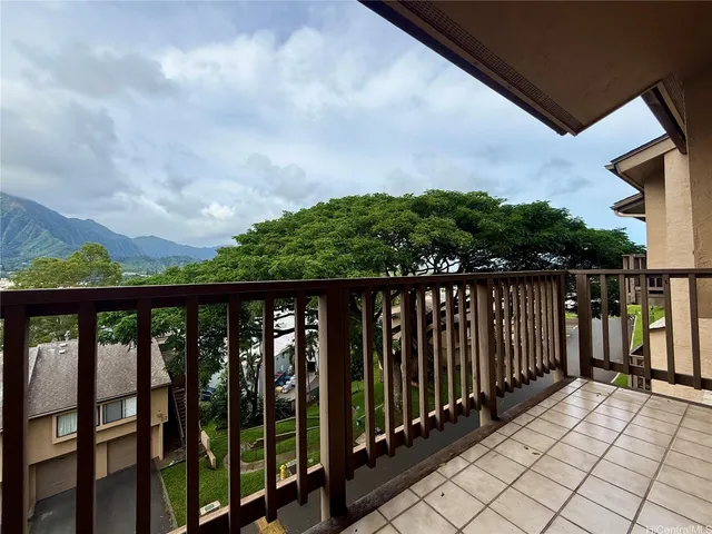 a balcony with wooden floor and city view