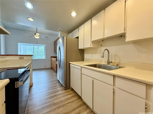 a kitchen with a sink appliances and cabinets