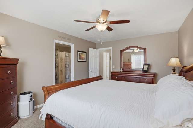 7737 Ranches Parkway Eagle Mountain, UT 84005 - Photo 11 of 28 Carpeted bedroom with a ceiling fan light fixture, neutral wall paint, and white trim
