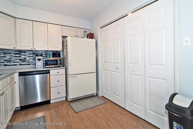 329 Briggs Avenue Forked River, NJ 08731 - Photo 7 of 15 a kitchen with cabinets a refrigerator and a stove
