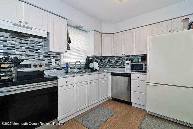 329 Briggs Avenue Forked River, NJ 08731 - Photo 8 of 15 a kitchen with granite countertop white cabinets and white appliances