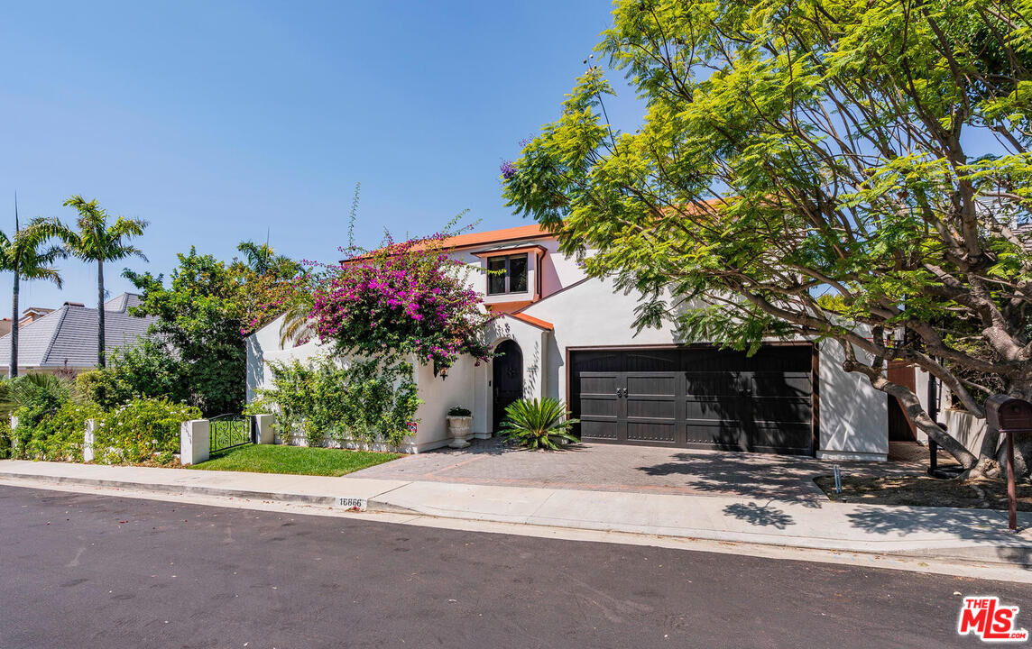 a front view of a house with a yard and a garage