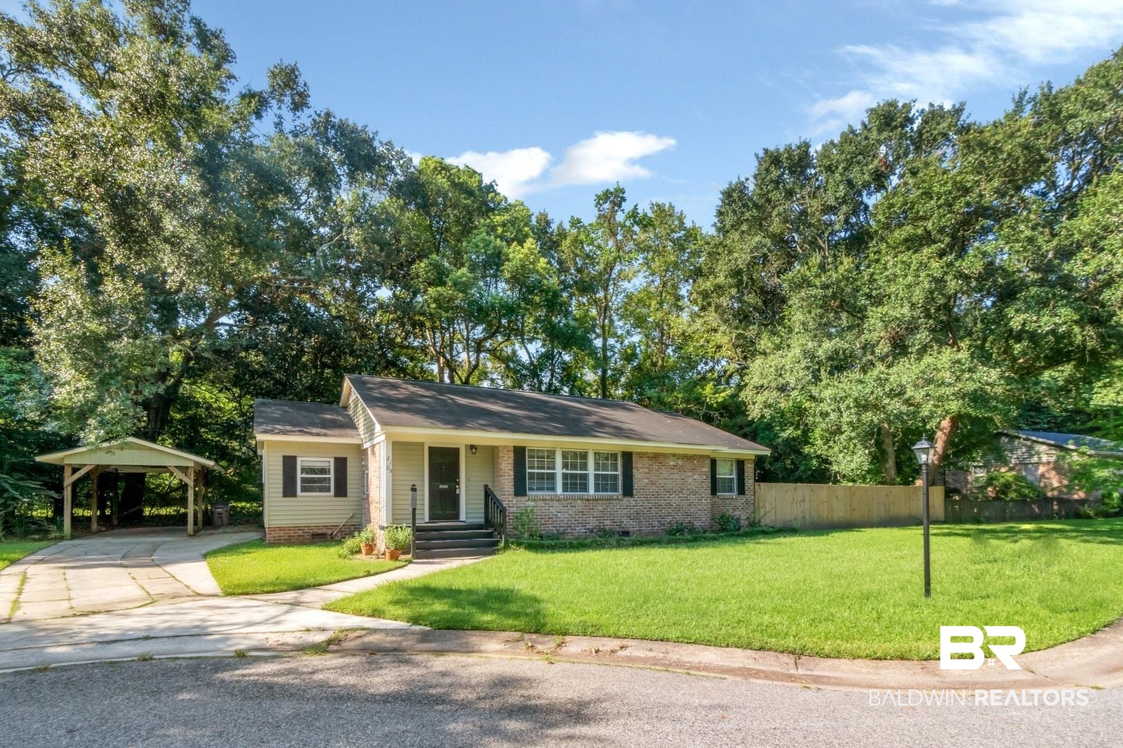 2105 Upham Court Mobile, AL 36607 - Photo 3 of 32 Single story home featuring crawl space, covered porch, brick siding, concrete driveway, and a carport