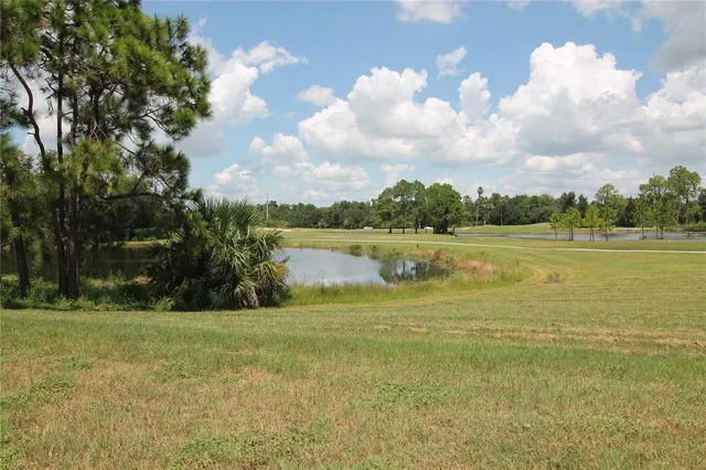 a kitchen with stainless steel appliances granite countertop a sink a stove oven a counter space and cabinets