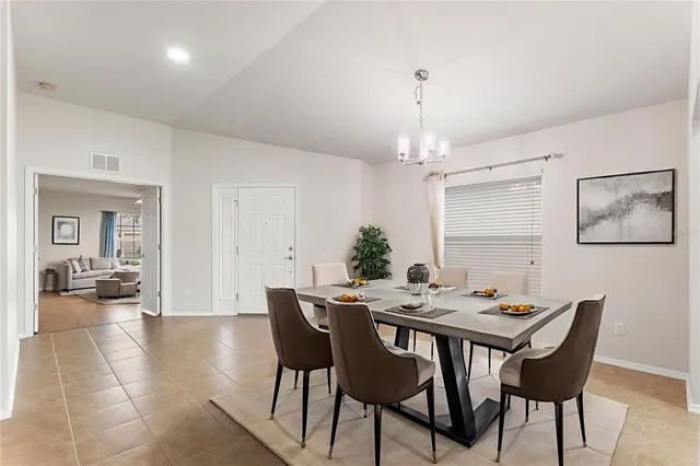 a bedroom with a large bed and a potted plant