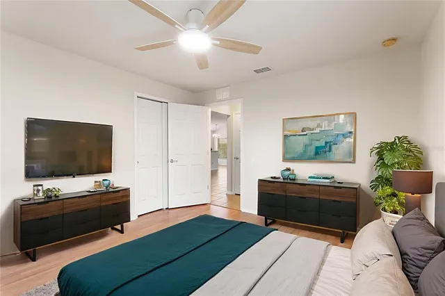 a view of an empty room with window and chandelier