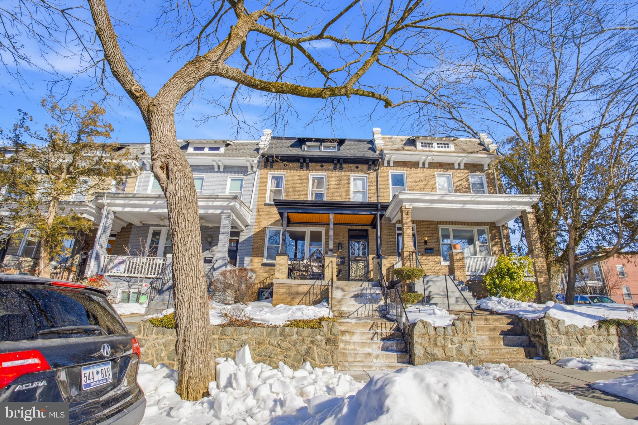 4903 9th Street Northwest Washington, DC 20011 - Photo 1 of 28 Charming row homes under a clear blue sky.