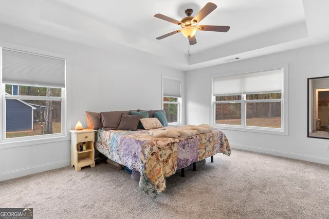 a spacious bedroom with a bed and a large window